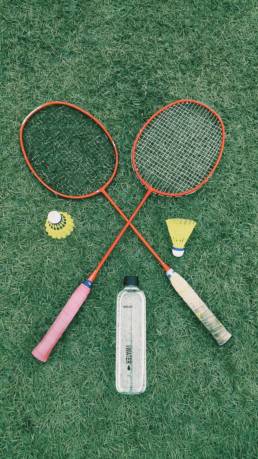 pair of red badminton rackets