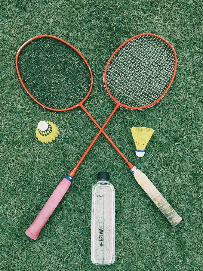 pair of red badminton rackets